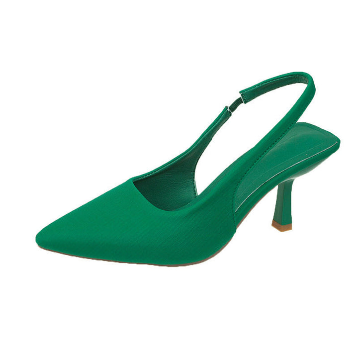 Formal women's black slingback pumps with a low heel and sophisticated narrow pointed toe.