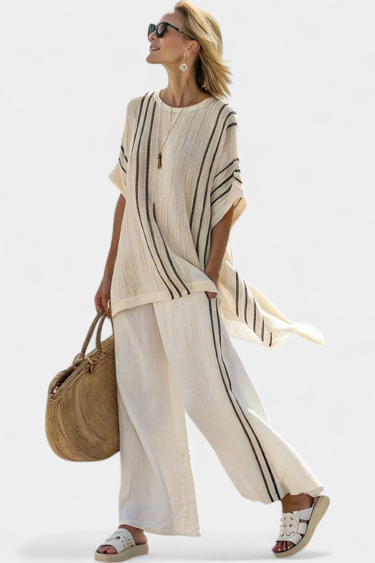 Stylish women's ensemble with an elegant ivory blouse and black striped wide-leg pants set for a sophisticated look.