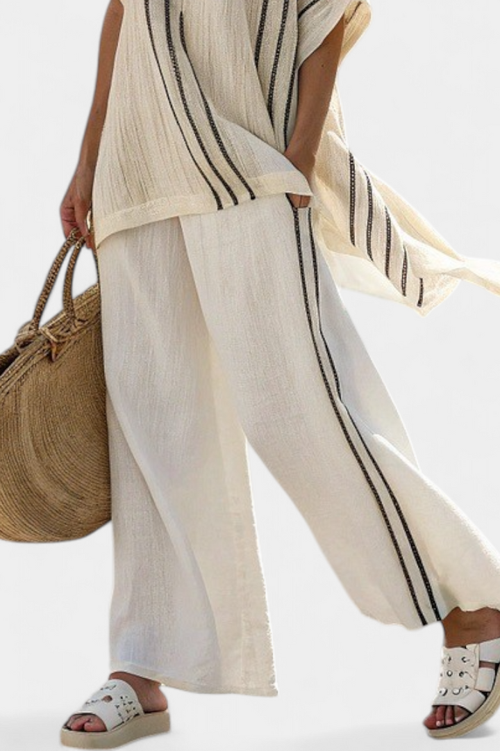 Comfortable women's ivory blouse & black striped wide-leg pants set, perfect for modern style and relaxed elegance.