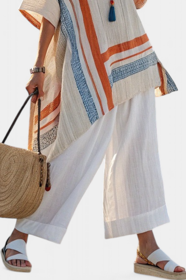 Stylish women's asymmetrical blouse and comfortable wide-leg pants. Versatile two-piece outfit for summer.