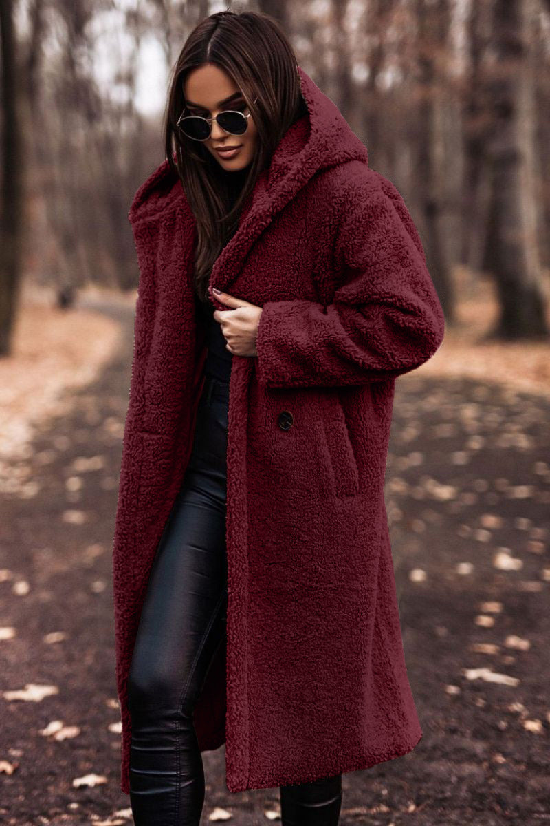 Warm women's longline plush coat with hood for winter, offering comfort & style.
