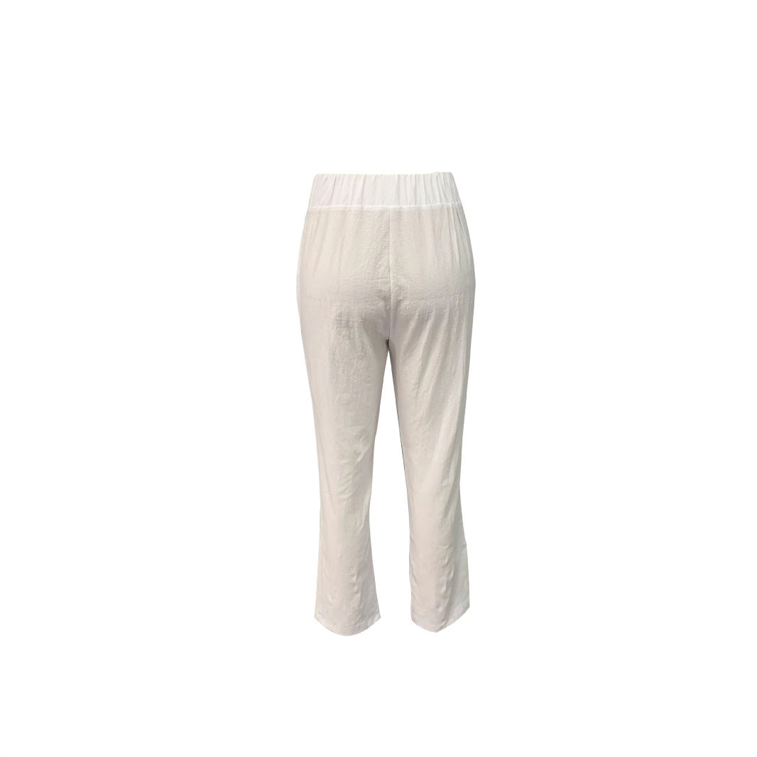 Casual white summer pants for women with an elastic waist, wide leg design & functional pockets.
