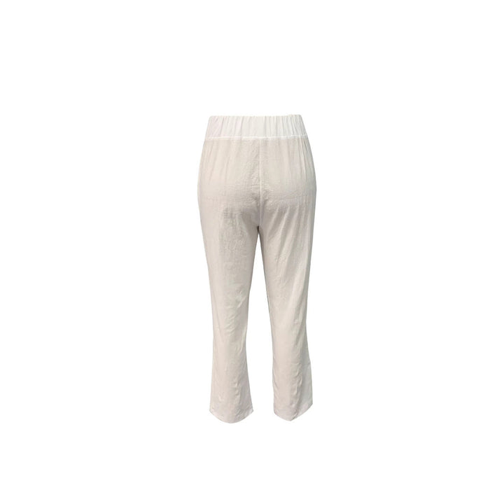 Casual white summer pants for women with an elastic waist, wide leg design & functional pockets.