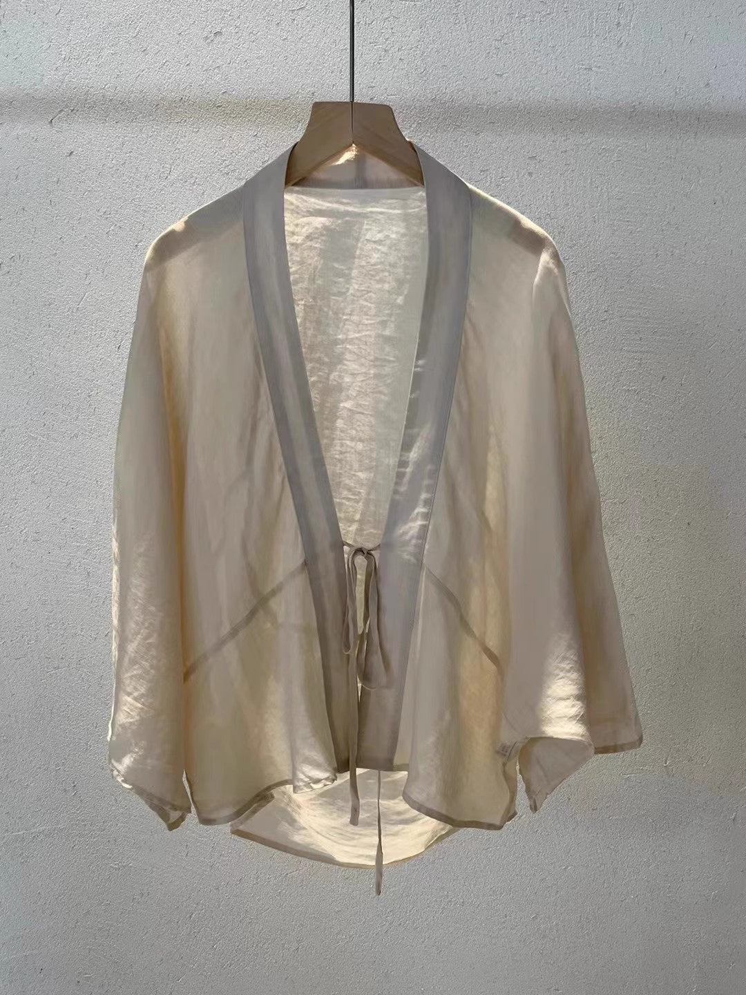 Chic sheer women's wrap jacket, ideal for versatile layering, a stylish summer jacket or elegant beach wear.