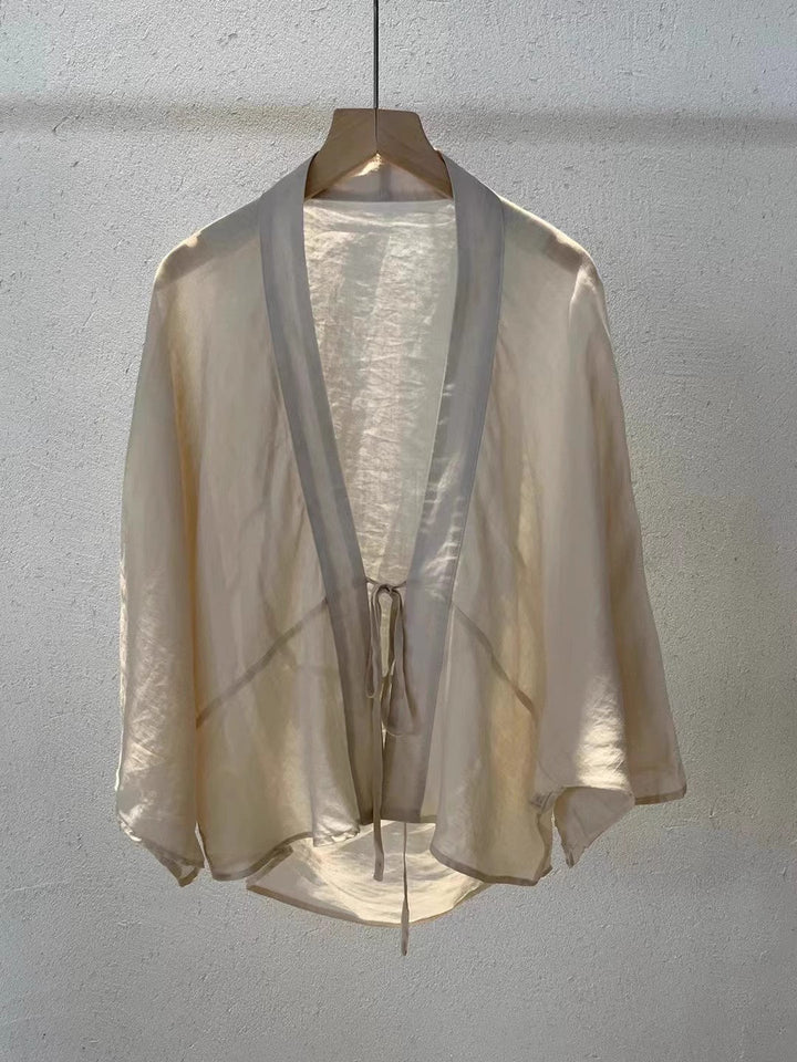 Chic sheer women's wrap jacket, ideal for versatile layering, a stylish summer jacket or elegant beach wear.