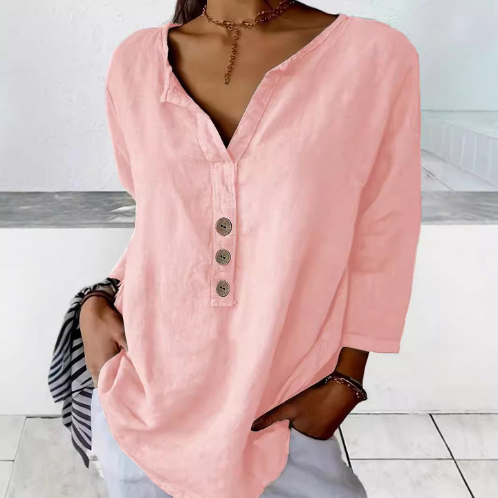 Relaxed fit women's button-down blouse, v-neck, 3/4 sleeves. Chic casual top ideal for comfortable summer style.