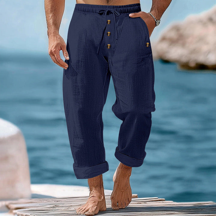 Folded men's casual relaxed fit pants, ideal for comfortable travel and warm weather vacations.