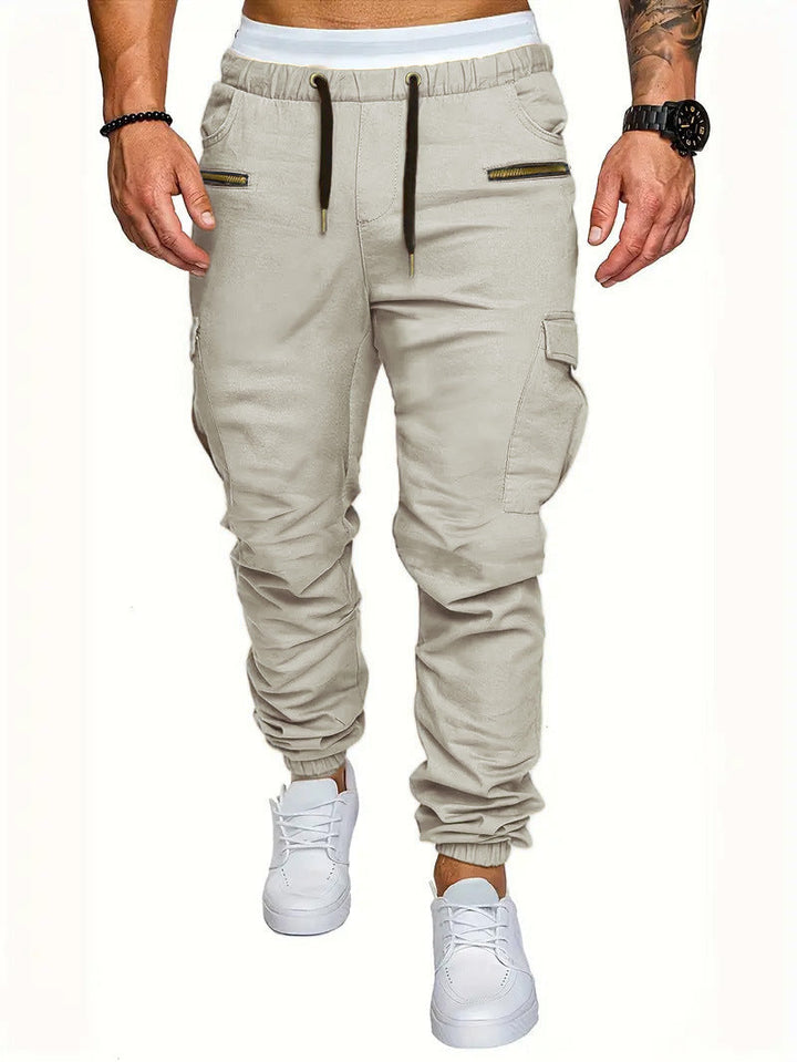 Fashionable men's cargo jogging pants, elastic waist, and multiple zip pockets, combining style and utility.
