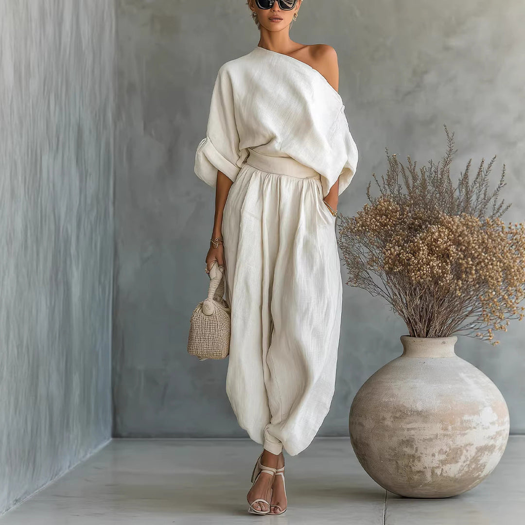 Versatile cream asymmetrical neckline loose fit jumpsuit, perfect for women seeking summer comfort & style.