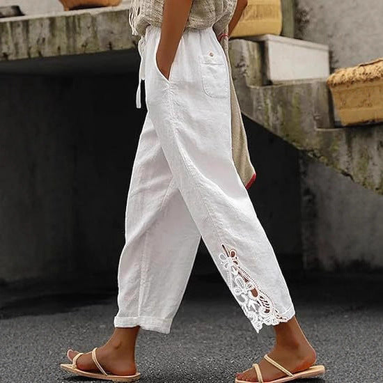 Women's embroidered trousers featuring unique side design, drawstring waist, and loose fit.