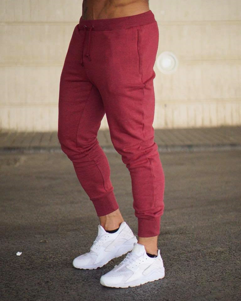 Man jogging in comfortable men's activewear pants, designed for athletic performance and freedom of movement.