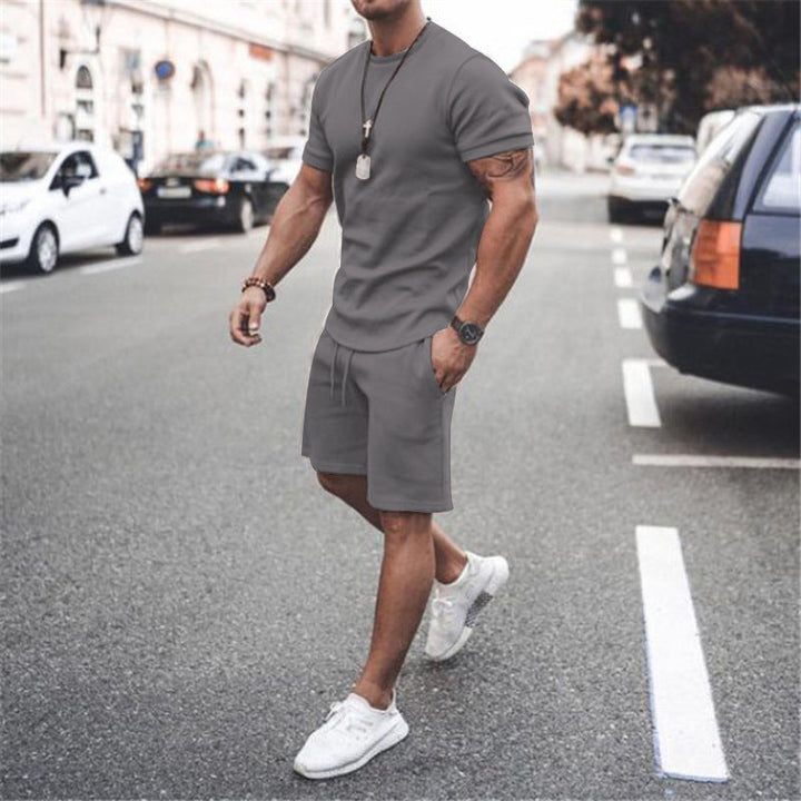 Grey men's summer workout outfit, a two-piece breathable tee & shorts set.