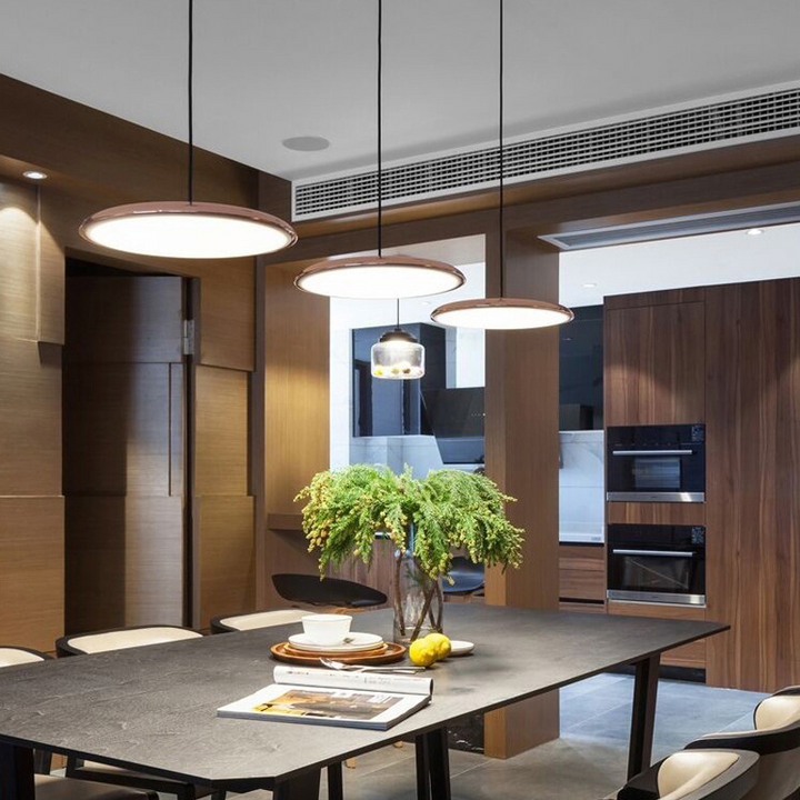 Nordic LED pendant lamp installed, providing sleek Scandinavian style and ambient lighting to a dining area.