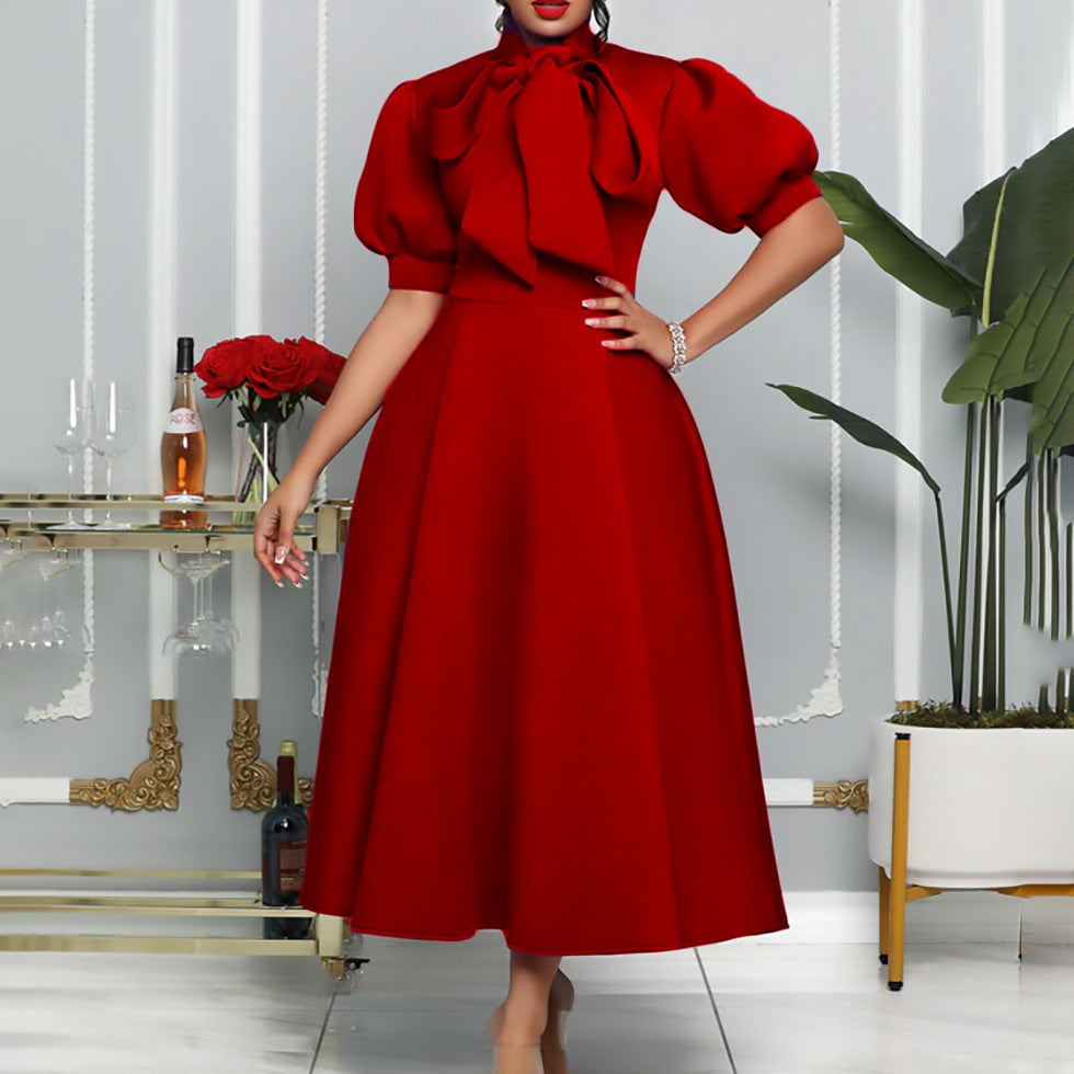 Modest women's maxi dress in a versatile style, with voluminous puff sleeves and a sophisticated bow neckline design.