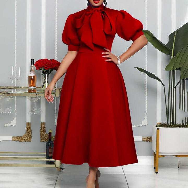 Modest women's maxi dress in a versatile style, with voluminous puff sleeves and a sophisticated bow neckline design.
