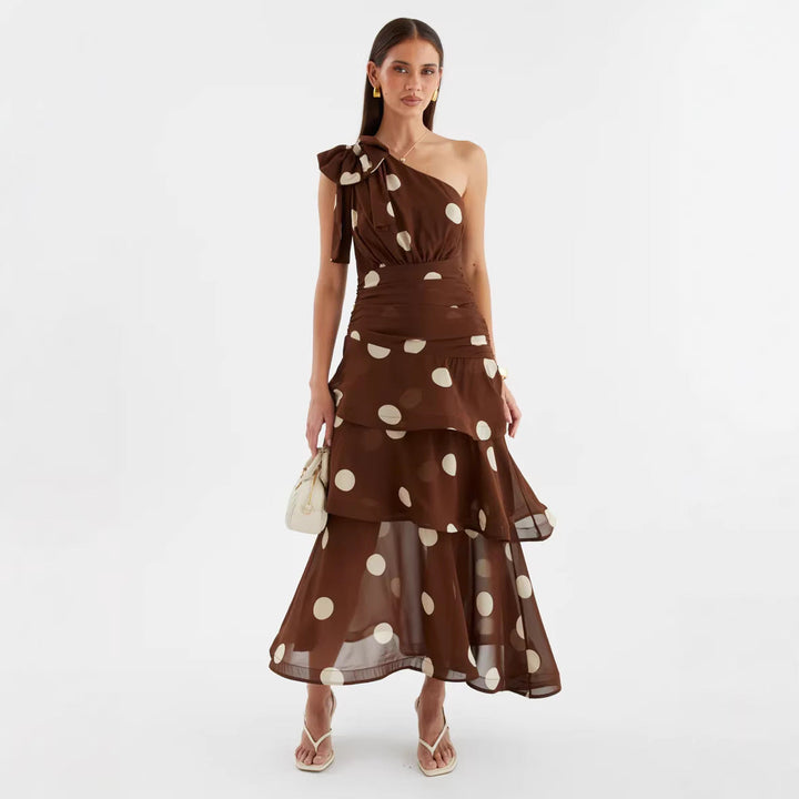 Flowy women's summer maxi dress with an elegant asymmetrical one-shoulder design and a full polka dot skirt.