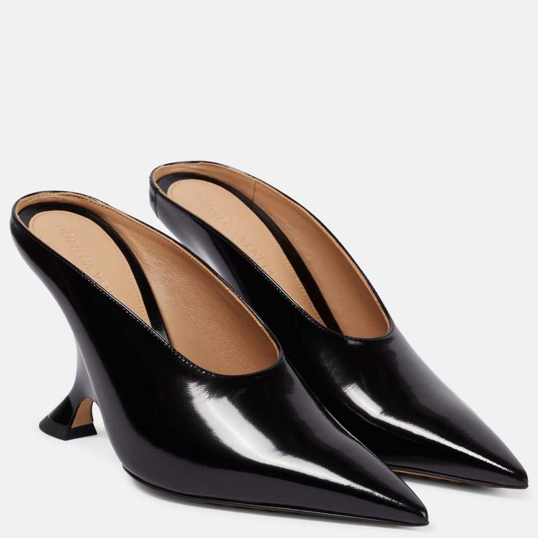 Fashionable women's comfortable metallic wedge mules with a pointed toe and modern sculpted heel design.