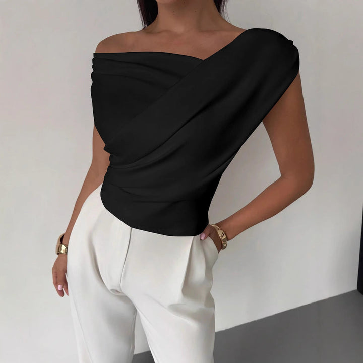 Modern women's elegant top, showcasing a unique draped asymmetric design. Stylish and comfortable blouse.