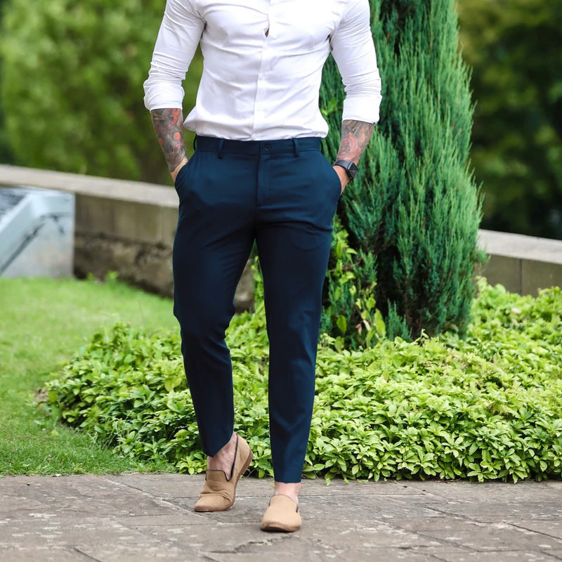 Side view: Men's slim-fit stretch trousers in deep navy, showcasing a contemporary and flattering cut.