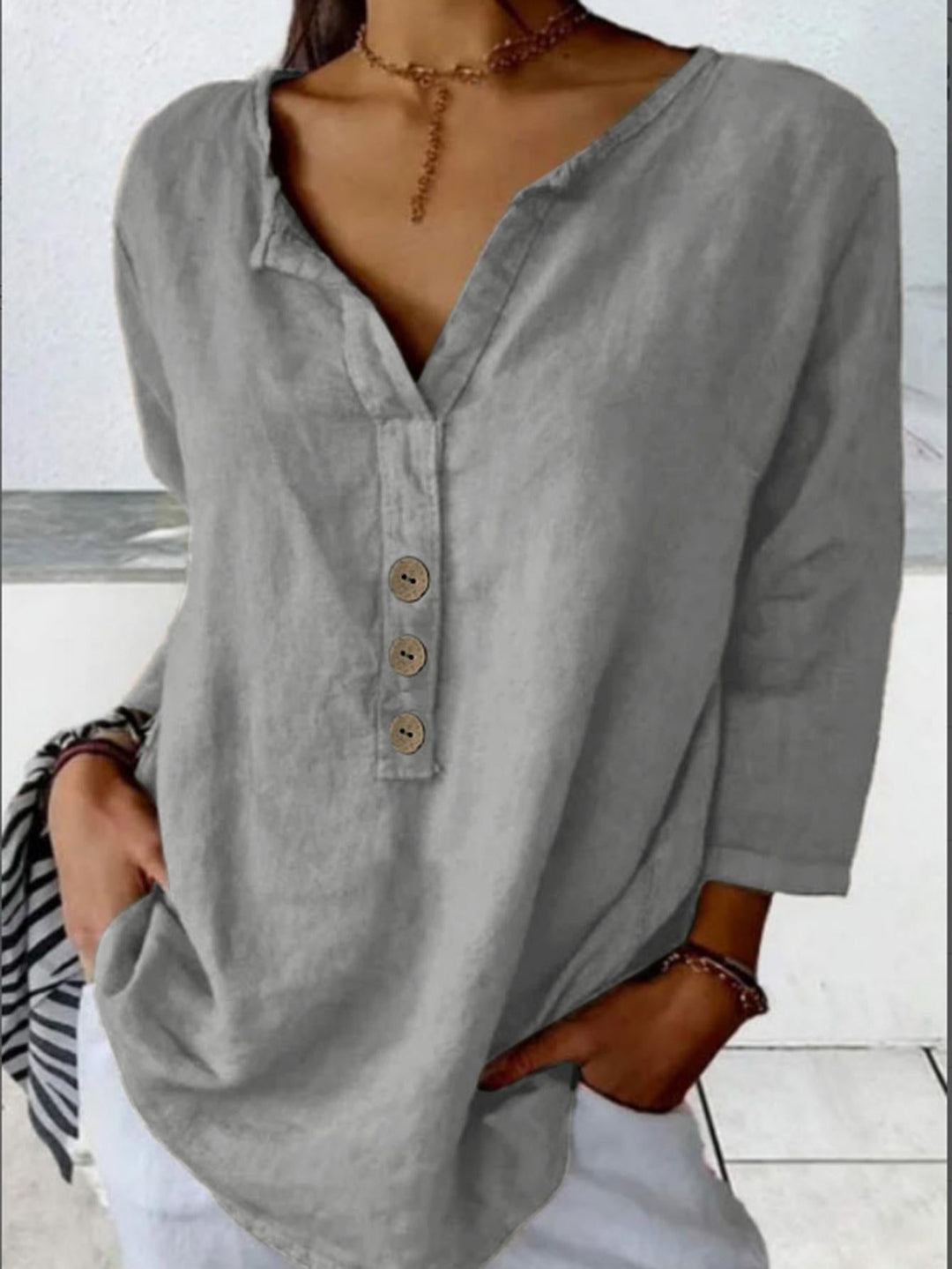 Versatile women's casual blouse: v-neck, 3/4 sleeve, button-down. Loose and comfortable for relaxed daily wear.