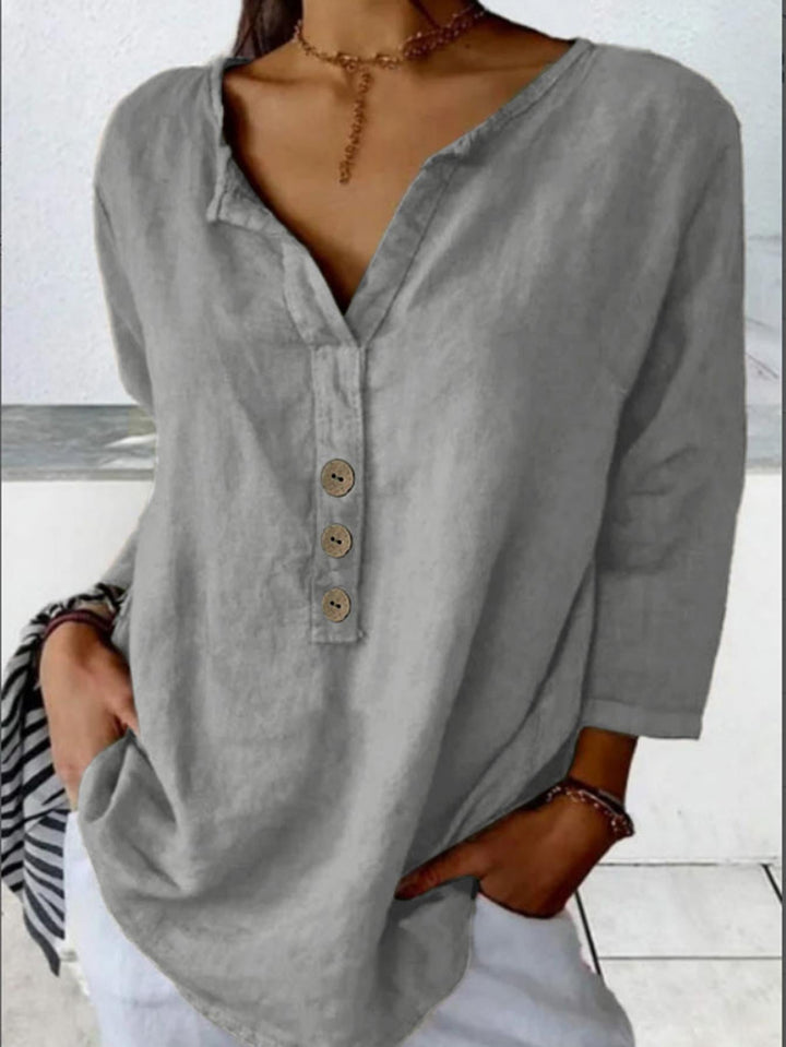 Versatile women's casual blouse: v-neck, 3/4 sleeve, button-down. Loose and comfortable for relaxed daily wear.