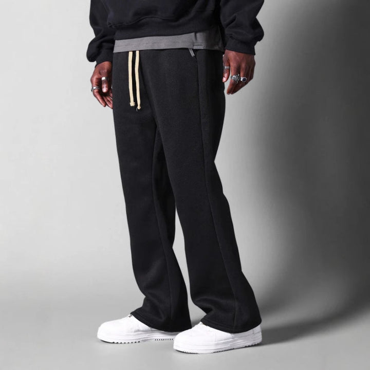 Fashionable men's flared sweatpants, designed for a relaxed fit, offering comfort and modern casual style.