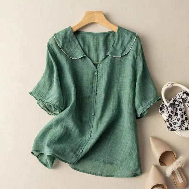 Women's vintage long-sleeve blouse with intricate button details, perfect for an elegant spring or autumn look.