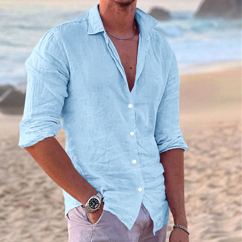 Men's lightweight button-down shirt unbuttoned. Casual summer fashion layered over a simple tee.