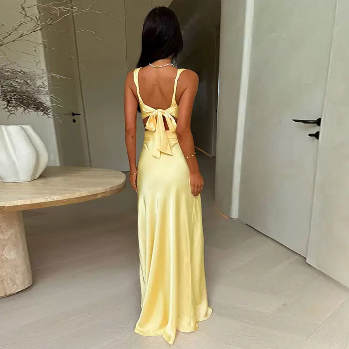 Glamorous long evening party gown for women, featuring a deep V-neck and stylish cut-outs.