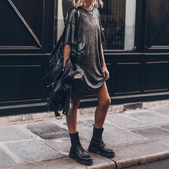 Comfortable women's oversized black glitter dress, shimmering with a chic side slit for a fashionable look.