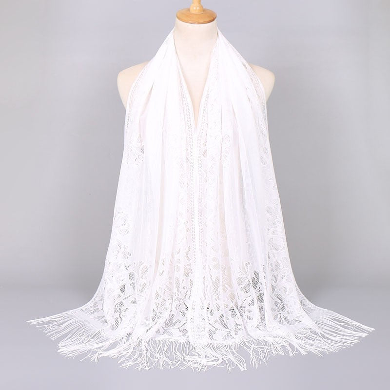 Stylish women's lace scarf with a floral pattern and delicate fringes, elegant fashion.