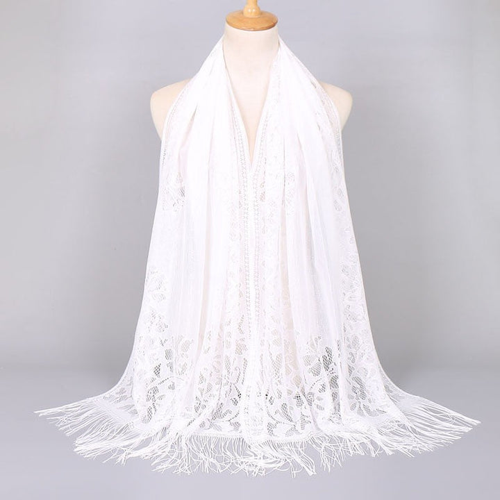 Stylish women's lace scarf with a floral pattern and delicate fringes, elegant fashion.