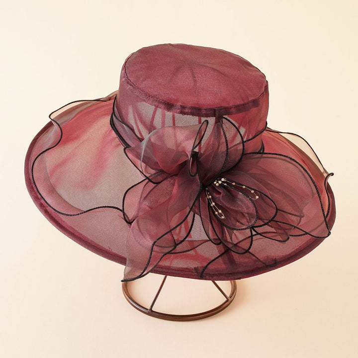Elegant women's wide brim sun hat with mesh design & romantic bow, offers stylish sun protection.