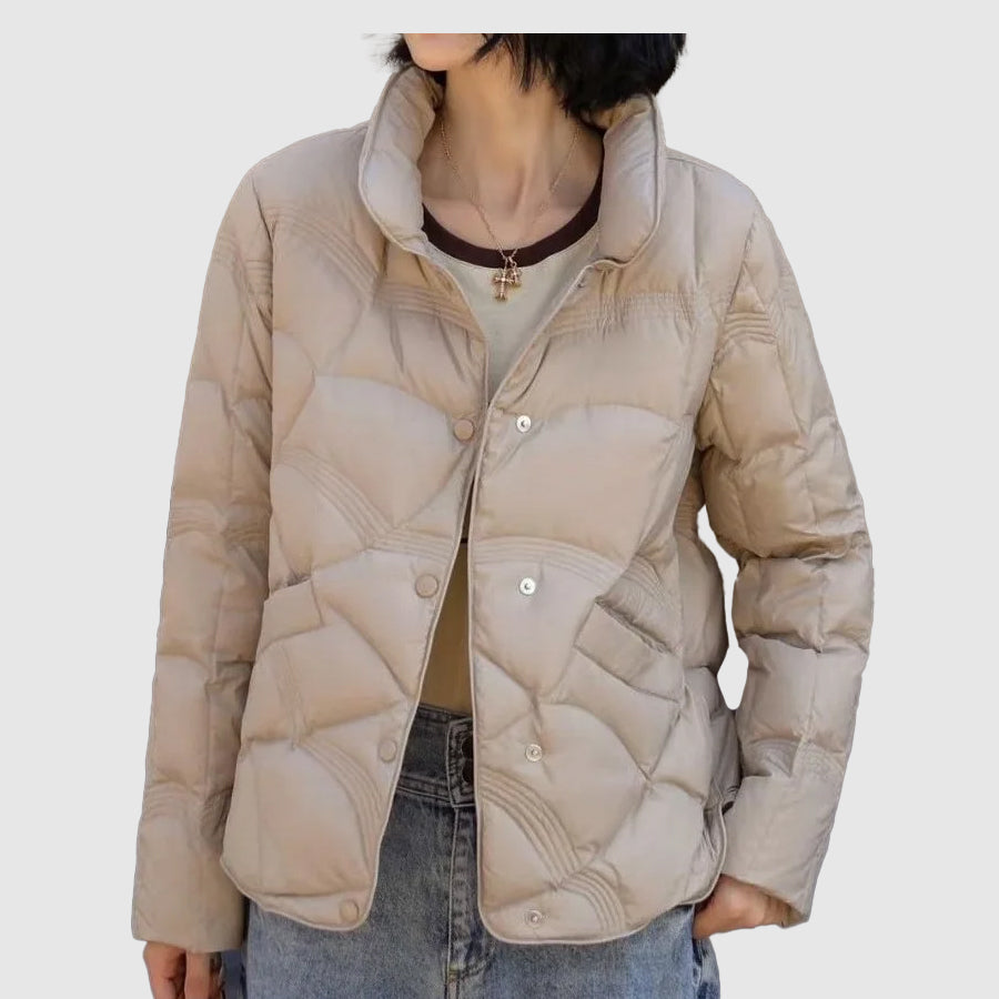 Fashionable black quilted winter jacket for women, a warm & casual outerwear coat for cold weather.