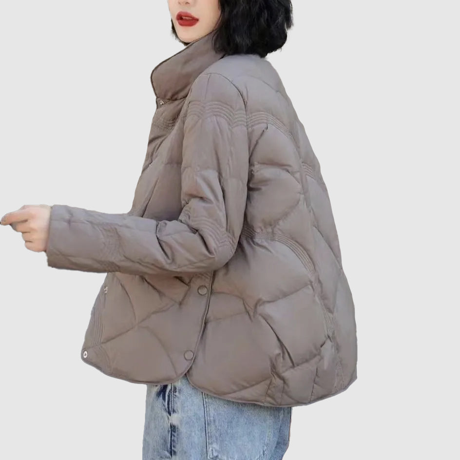 Warm women's quilted winter jacket, a trendy and comfortable outerwear piece for cold weather fashion.