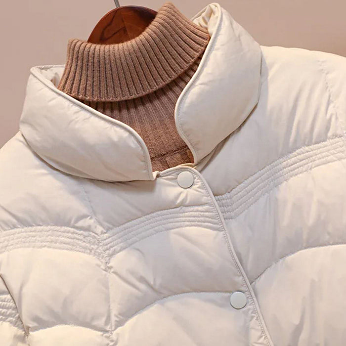 Trendy women's warm beige quilted winter jacket, perfect for cold weather fashion outerwear.