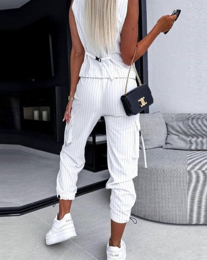 Chic striped women's suit set featuring a versatile vest, top, and matching pants. Fashionable ensemble.