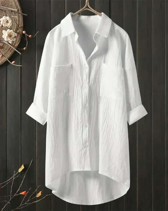 Women's flowy white long-sleeve blouse for elegant everyday wear. Loose fit, comfortable summer top, versatile style.
