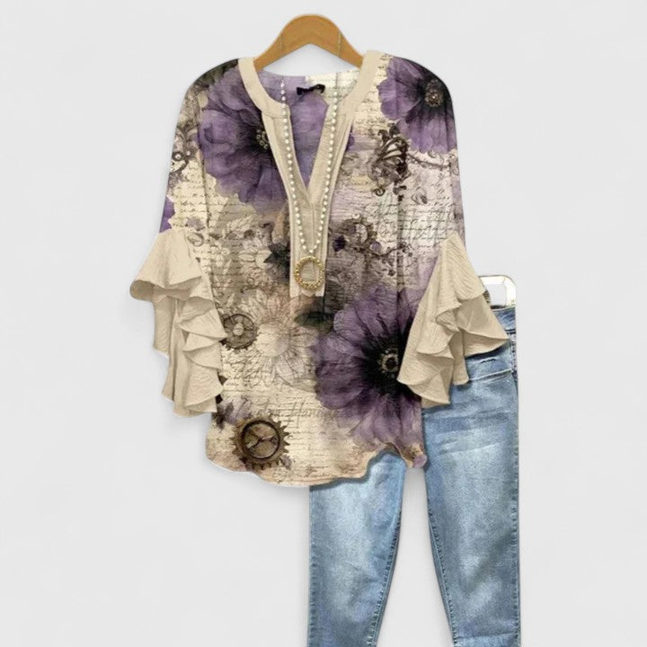 Women's fashion top: elegant floral blouse with delicate ruffle sleeves, ideal for versatile chic outfits.