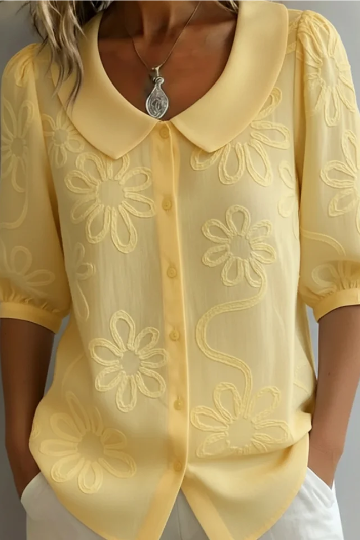Women's elegant floral blouse with a relaxed fit. Perfect for office or casual spring fashion.