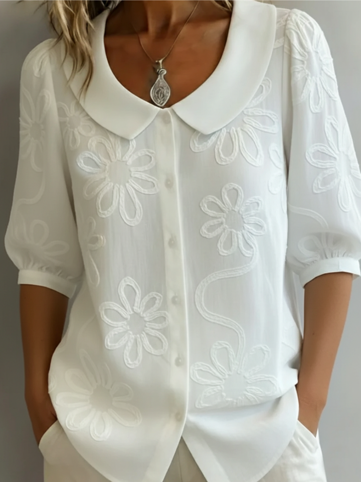 Plus size women's floral embroidered short sleeve blouse. A stylish round neck casual elegant top.
