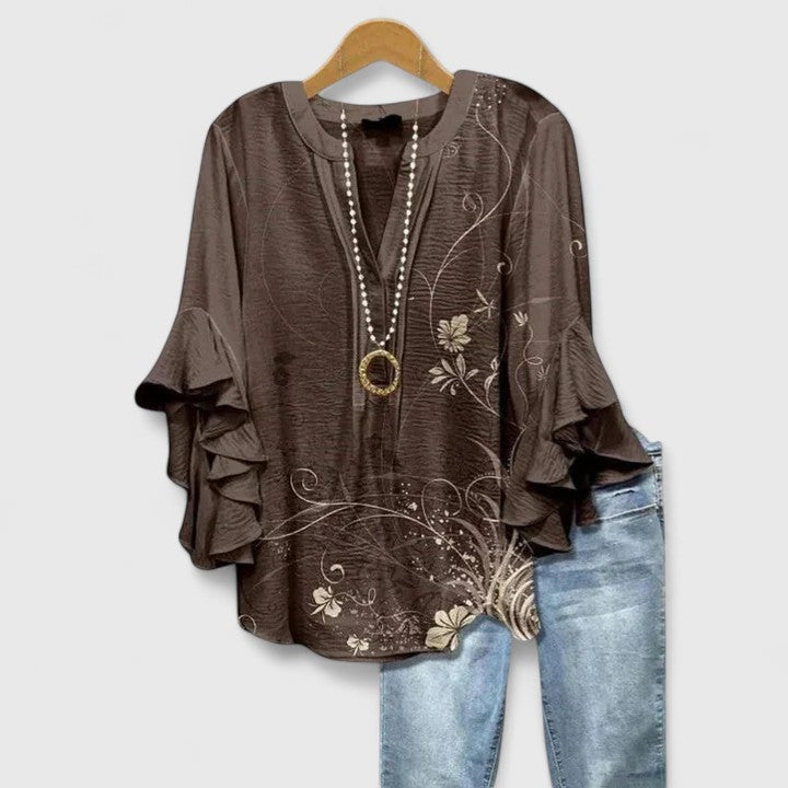 Casual yet elegant women's floral blouse with ruffle sleeves, a chic and comfortable fashion top.