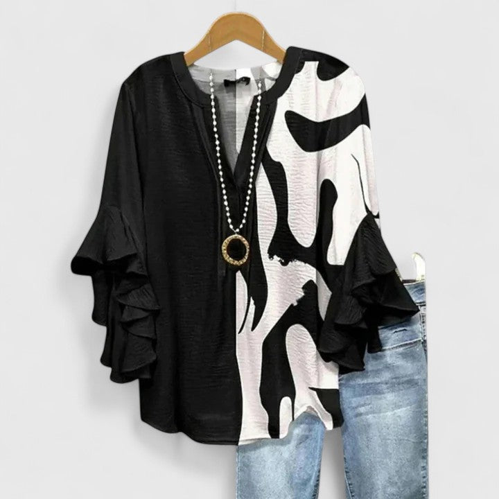 Vibrant floral print women's blouse featuring stylish ruffle sleeves, an elegant and feminine fashion piece.