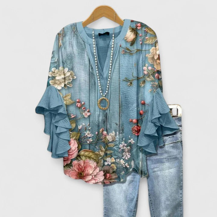Sophisticated women's blouse with an elegant floral design and chic ruffle sleeves, perfect for any occasion.