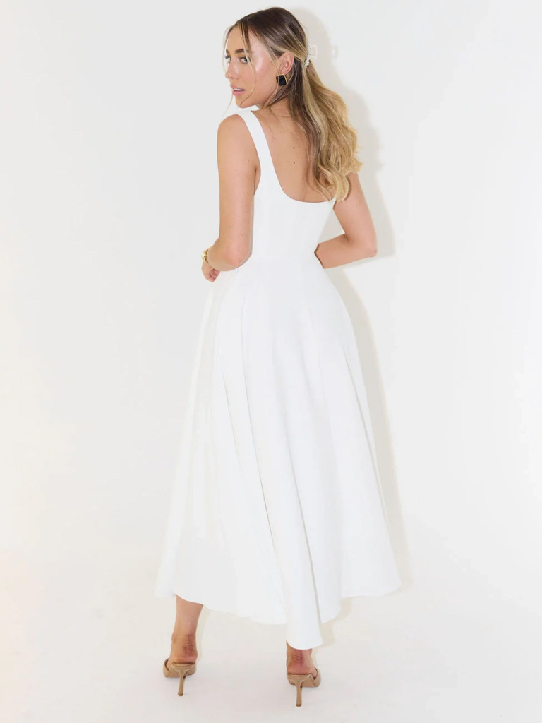 Elegant midi dress for women, styled with accessories for a chic summer look.