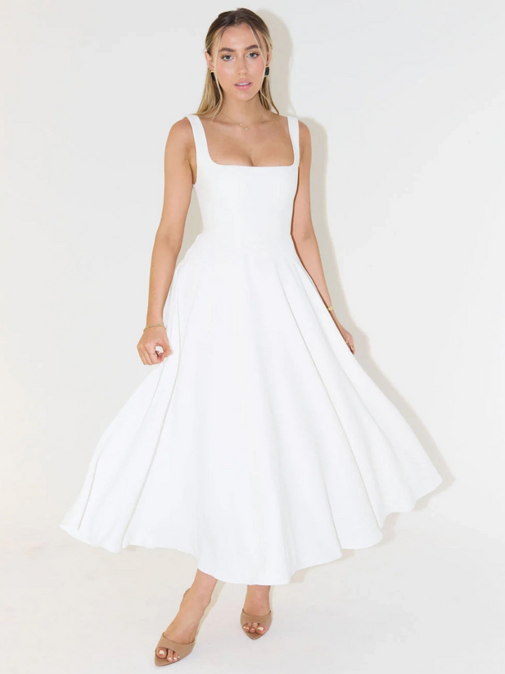 Studio shot of versatile women's elegant midi dress, ideal for summer occasions & style.
