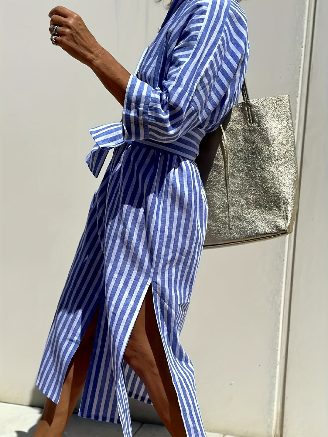 Elegant striped shirt dress for women, featuring three-quarter sleeves & a stylish split hem.