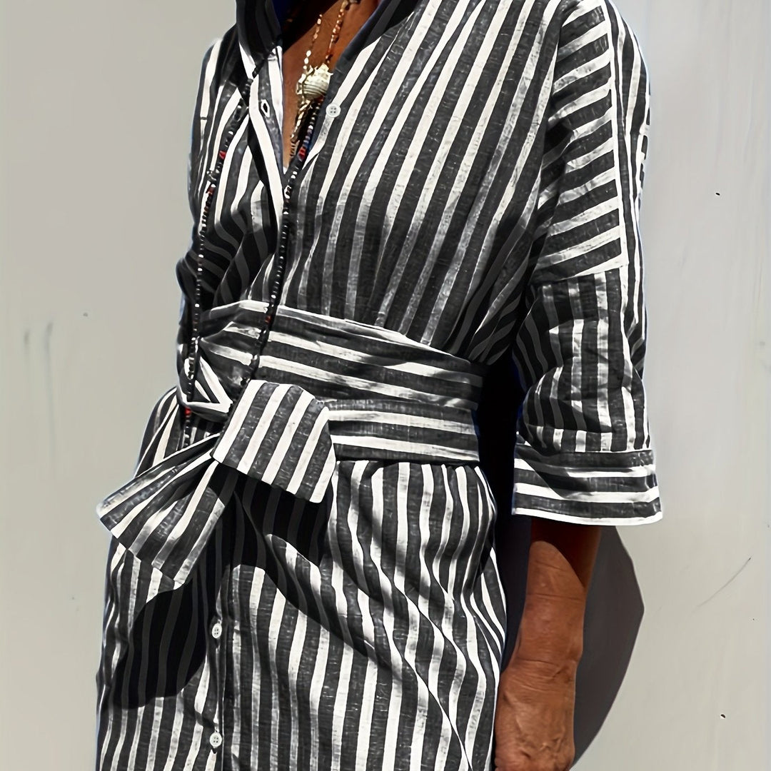 Classic striped pattern on a women's button-down midi dress, cinched at waist with belt.