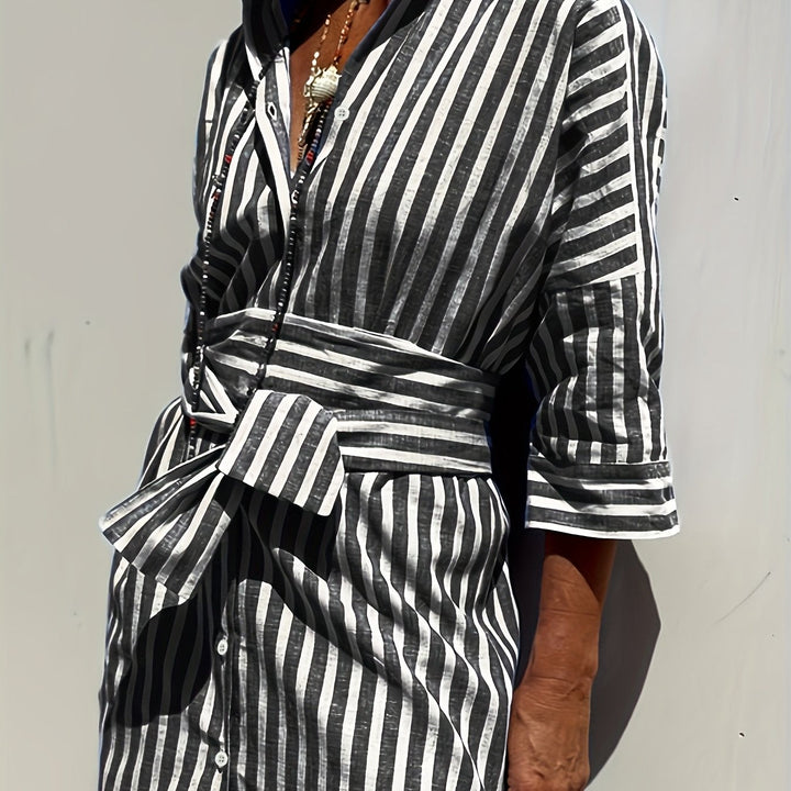 Classic striped pattern on a women's button-down midi dress, cinched at waist with belt.