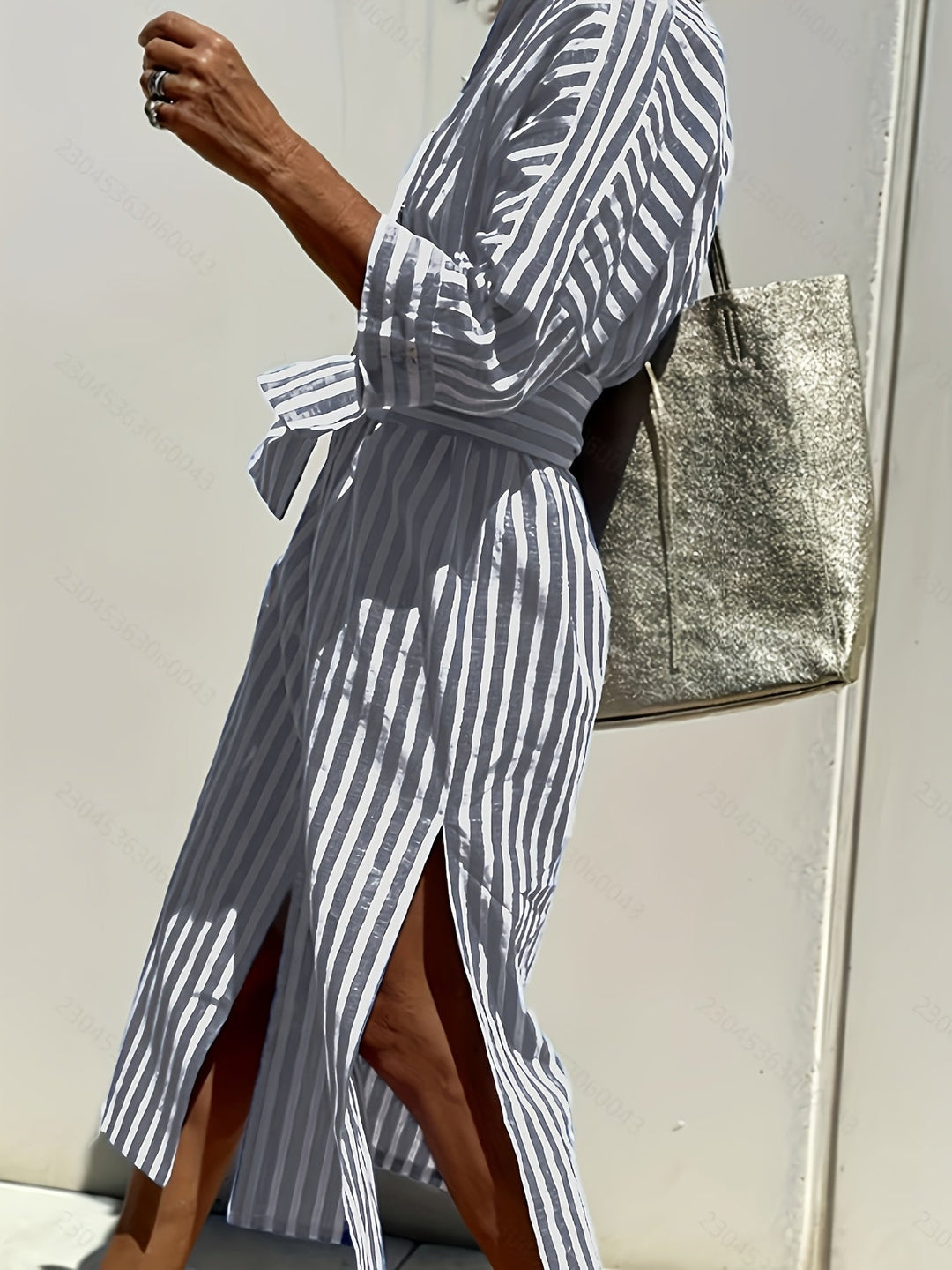 Detail of buttons & belt on a women's striped shirt dress, highlighting quality and style.